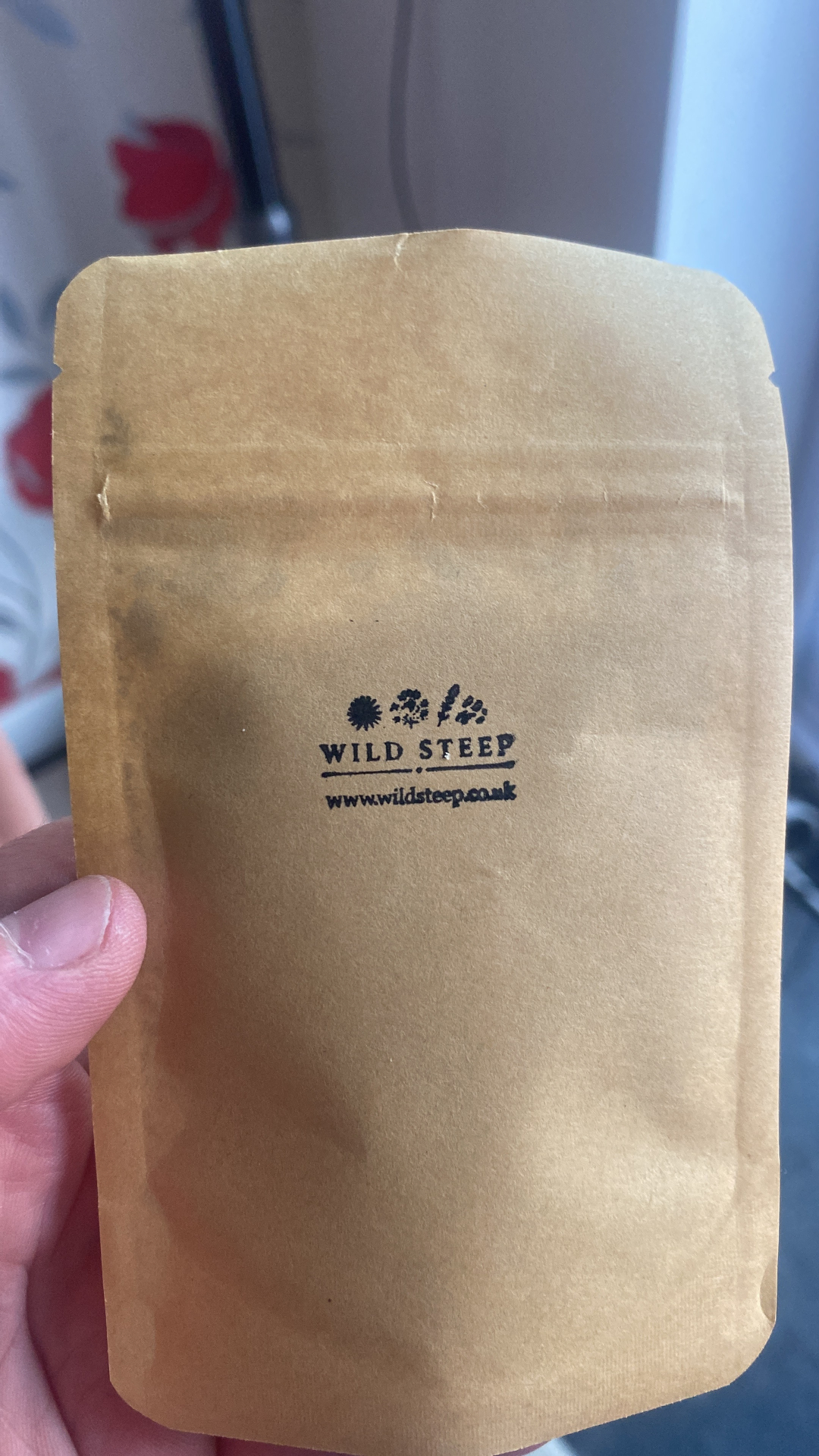 A Wild Steep kraft pouch stamped by hand with the botanical mark and logo.